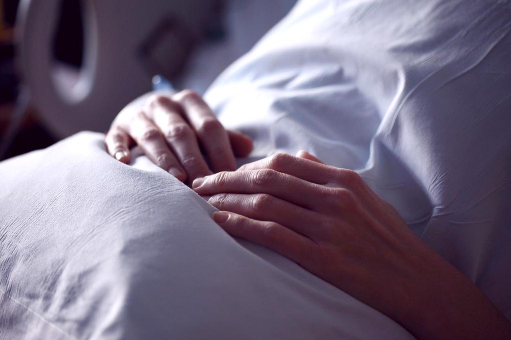 Woman sleeping peacefully in a well-lit bedroom for better rest