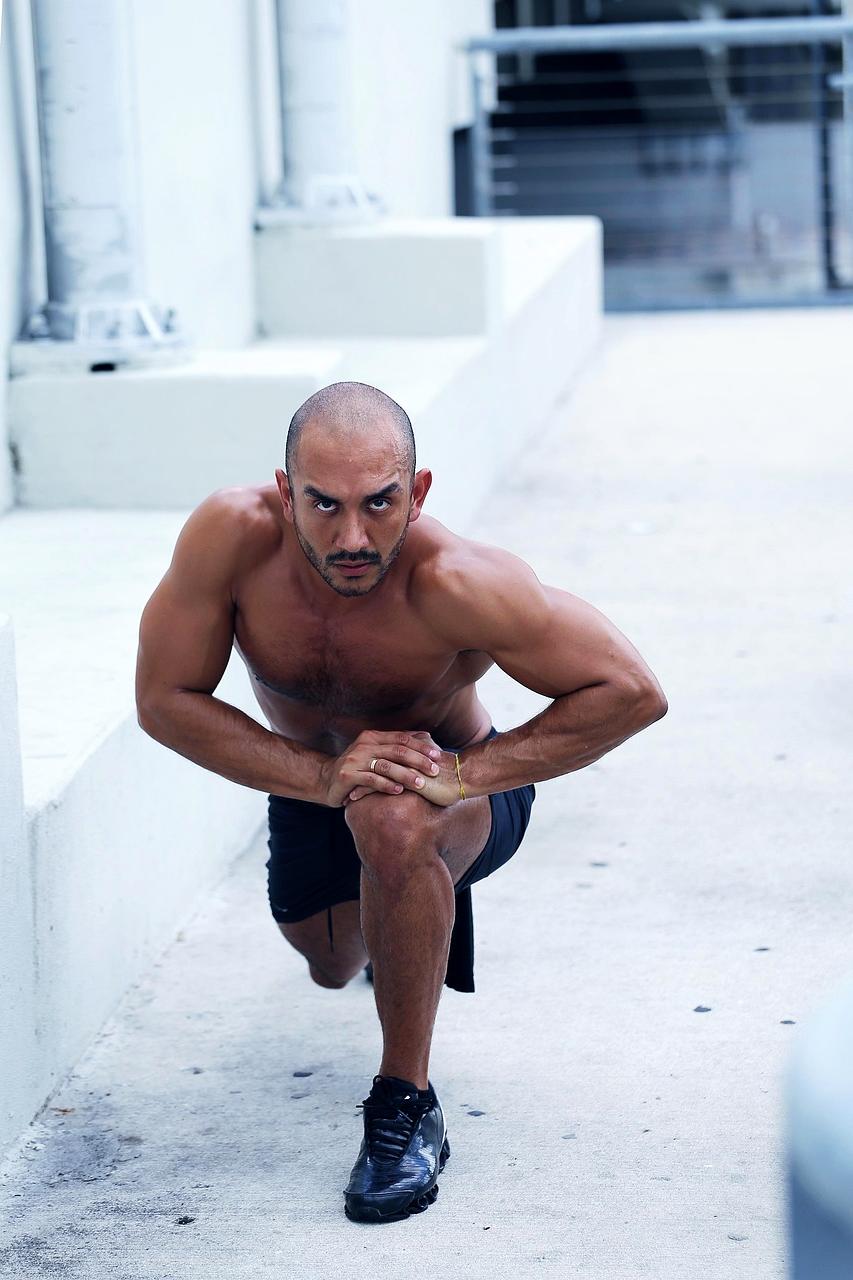 Fitness trainer assisting client with workout routine